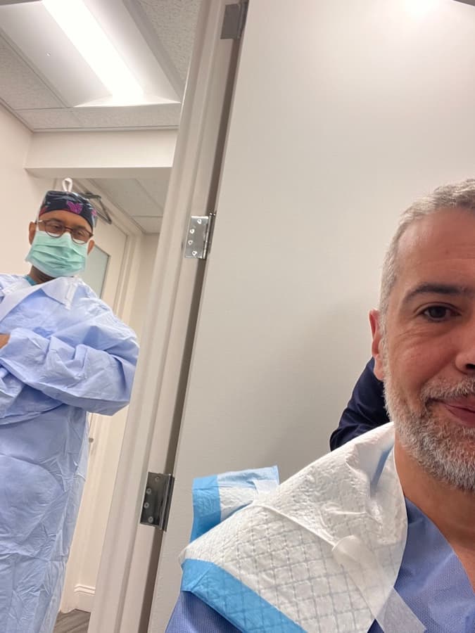 Joe Garraffo in a surgical gown on procedure day, his surgeon behind him
